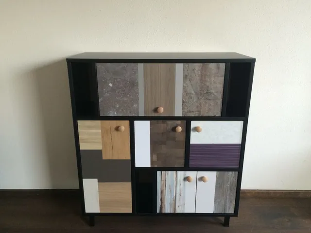 Zwarte kast met fronten van verschillende houtstaaltjes